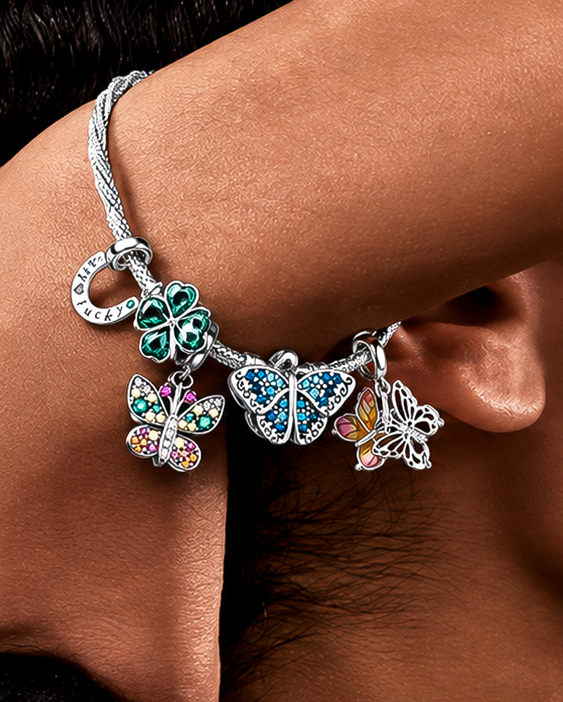 Charm bracelet with butterfly and clover charms